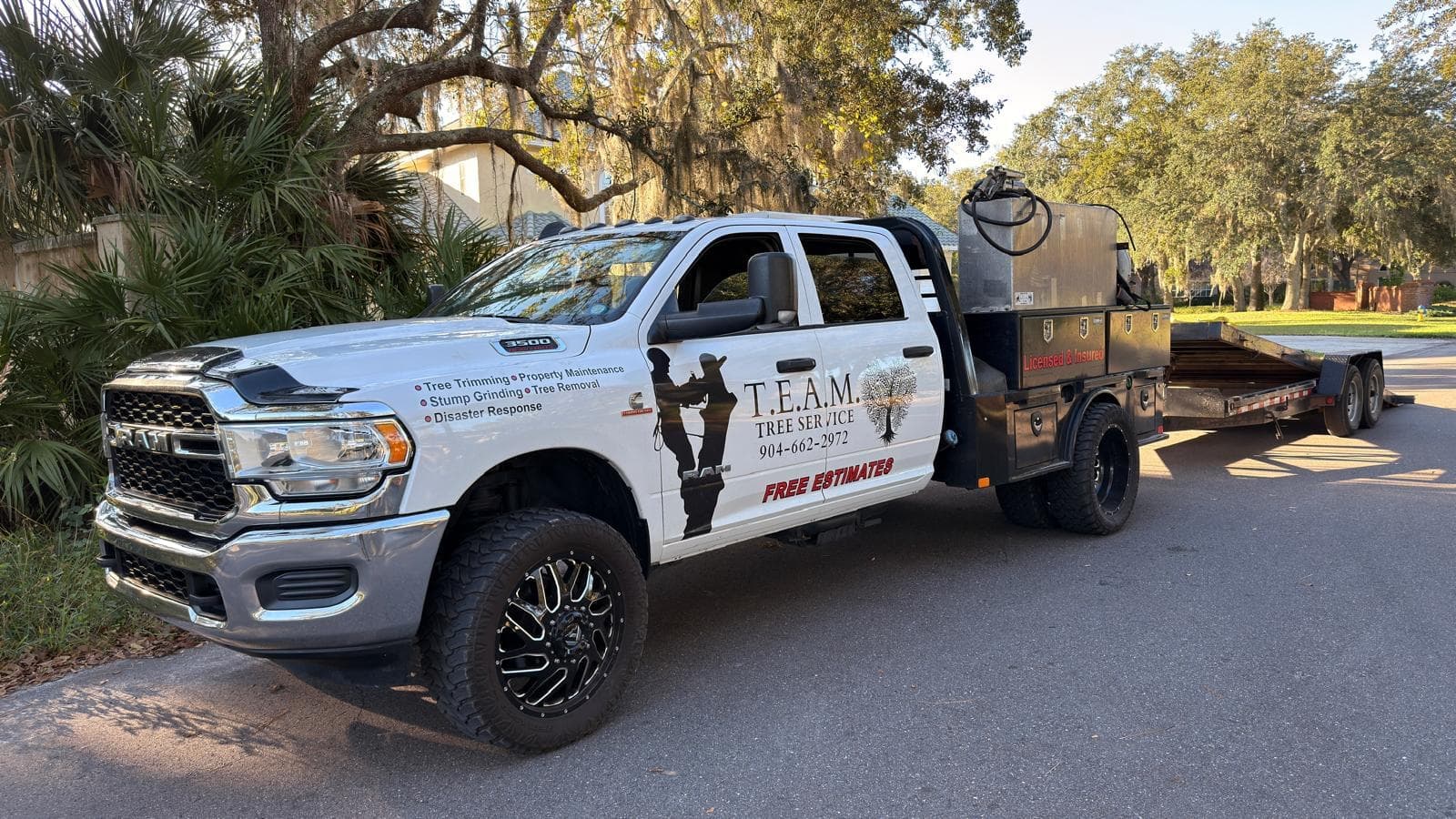 T.E.A.M. Tree Service truck and equipment at a work site