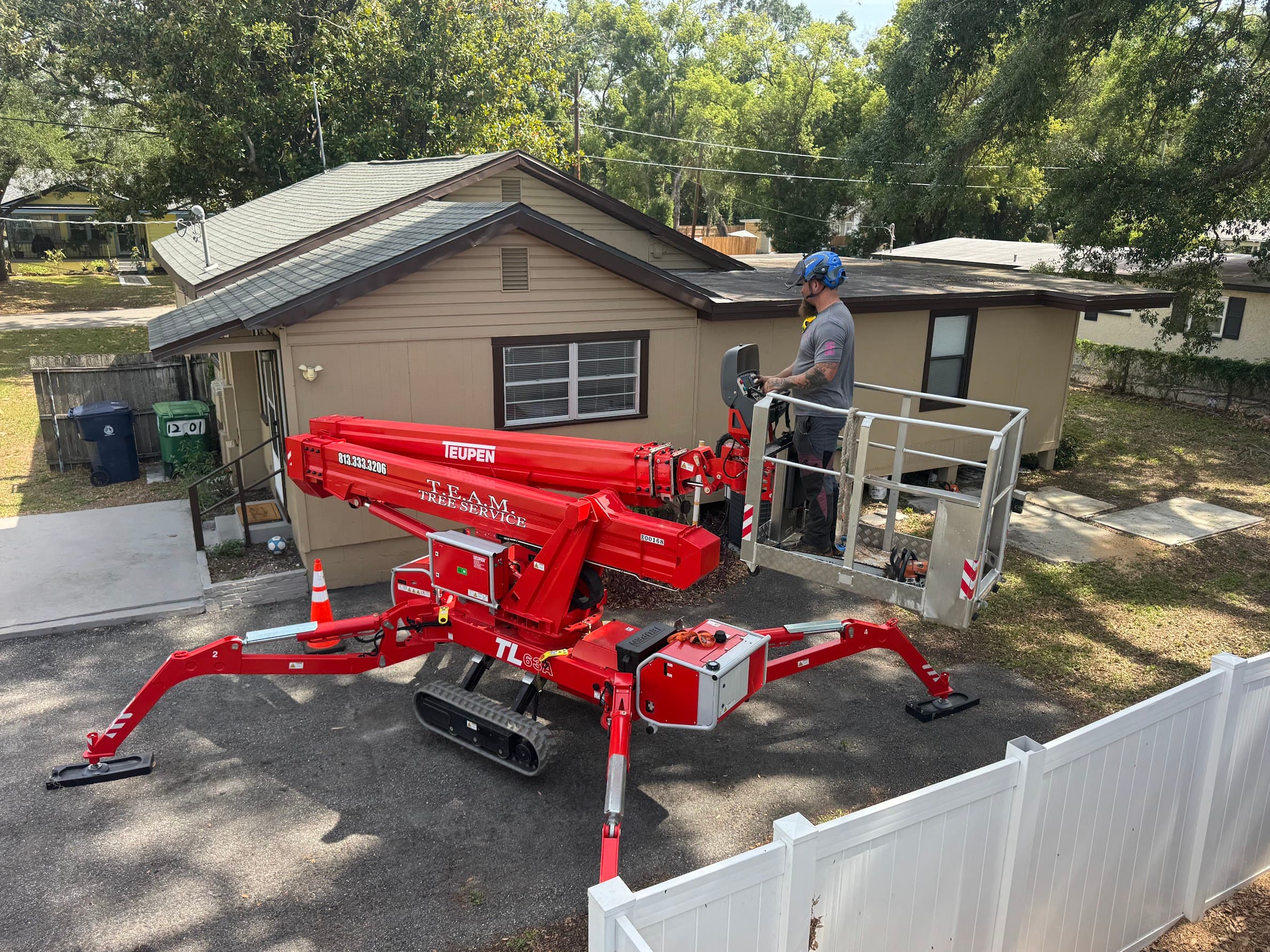 T.E.A.M. Tree Service aerial lift set up for canopy work