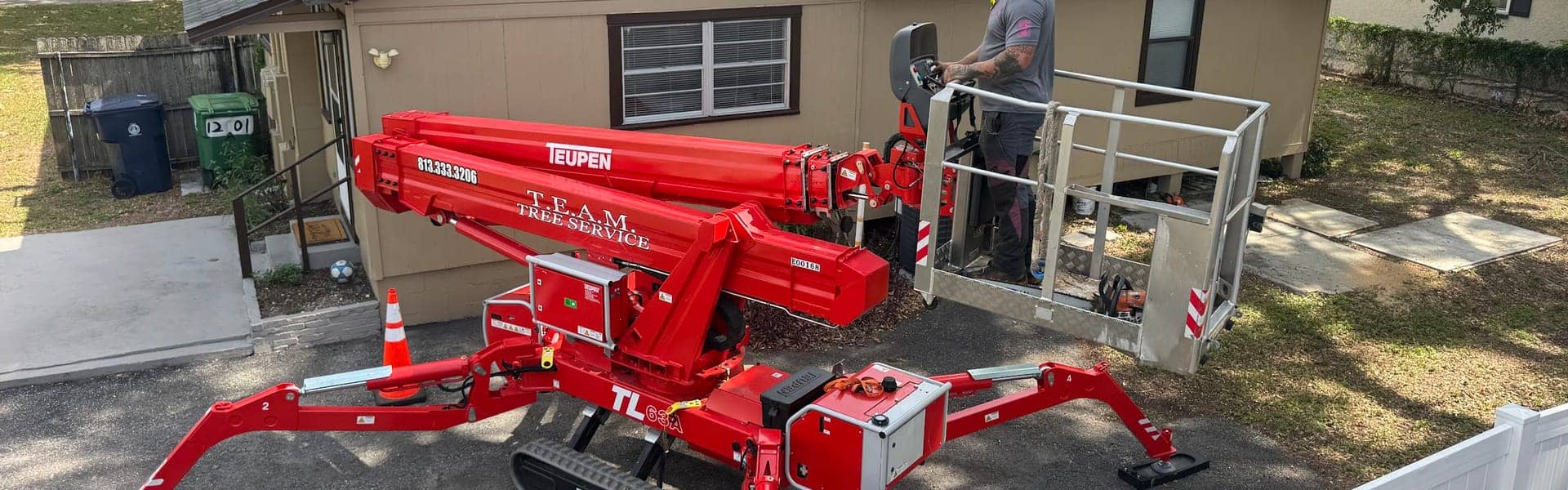 T.E.A.M. Tree Service aerial lift set up for canopy work